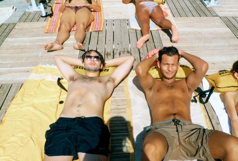 Two friends sunbathing on a wooden deck, digital RAW with Cinea Ultramax 400